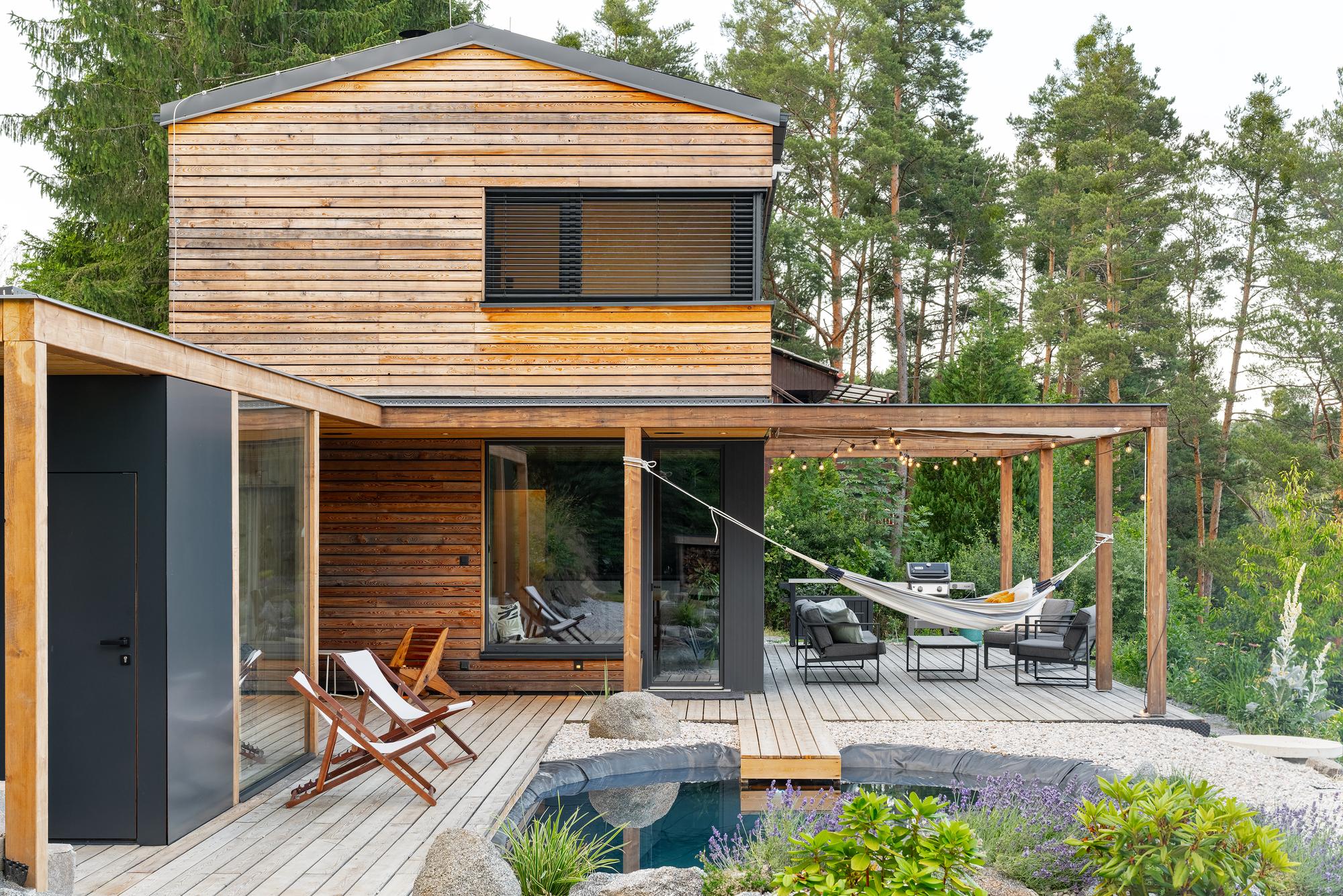 The whole house from the garden, with the pergola, deck and swimming pond